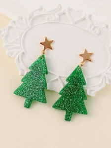 Detail of glittery green Christmas tree earrings with gold star studs on vintage frame