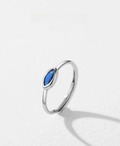 Detailed macro view of an adjustable S925 silver ring with marquise blue gem