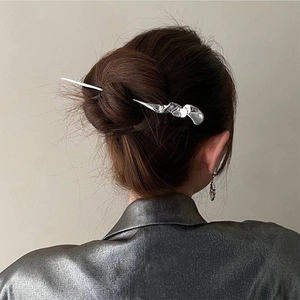 Silver metallic liquid style hair pin shown on elegant updo with high-mirror finish