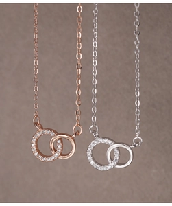 Close-up of interlocking rings necklace in rose gold and silver finish with pavé zircon