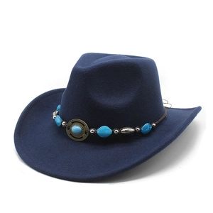 Close-up of navy blue felt cowboy hat with turquoise beads and retro metal ornament