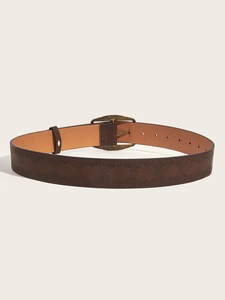 Detailed macro view of vintage brown embossed leather belt with bronze metal pin buckle