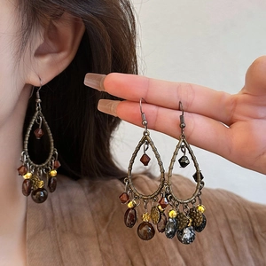 Vintage bronze teardrop earrings with ethnic beads and pendants in bohemian style