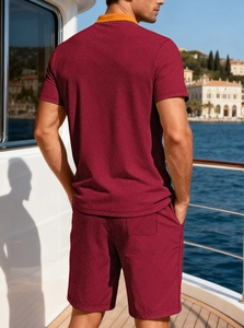 Men's burgundy knit polo set with orange collar shown on a yacht deck background