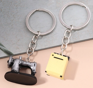 Detail of vintage sewing machine keychain charm with yellow block on textured background