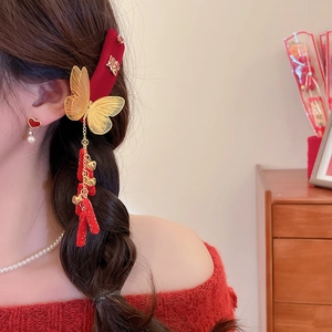 Detail of red velvet butterfly hair clip with gold tassels and bells for Chinese New Year