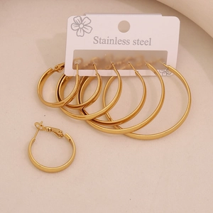 Detailed set of golden stainless steel geometric hoop earrings on display card