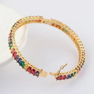 Detail of bohemian rainbow zircon bracelet featuring multi-colored gemstones in gold plating