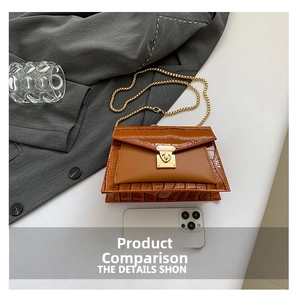 Detail view of brown crocodile texture flap bag with gold chain and metal lock closure