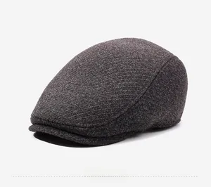 Detailed side view of dark grey thick wool blend fabric texture on mens winter ivy cap