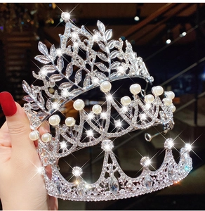 Close-up of sparkling crystal and pearl princess crown tiara with silver alloy frame