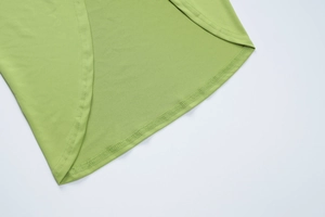 Detailed close-up of fruit green dress featuring curved hem and reinforced double stitching