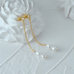 Detailed macro view of S925 sterling silver hallmark on gold pearl tassel earrings