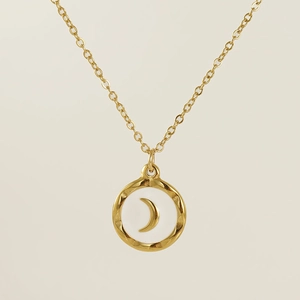 Macro detail of 18K gold stainless steel moon pendant with white enamel inlay