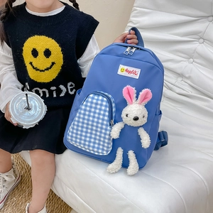 Blue cartoon kids backpack with checkered front pocket and white plush bunny pendant