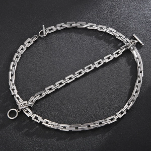 Macro shot of silver stainless steel rectangle chain necklace with OT toggle clasp