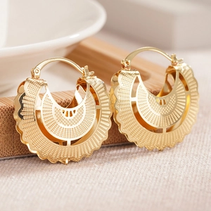 Elegant gold-plated hollow scalloped hoop earrings with intricate dot-patterned metalwork