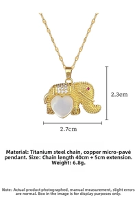 Macro detail of elephant pendant with white opal heart and zircon inlays on gold chain