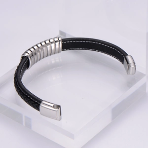 Braided leather and stainless steel bracelet with magnetic clasp on acrylic stand