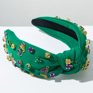 Detailed shot of green Mardi Gras headband with colorful rhinestones and gold enamel charms