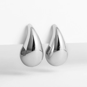 Macro shot of silver teardrop earrings with high-polished mirror finish and sleek design
