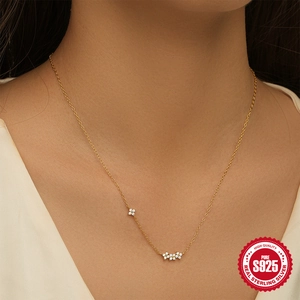 925 sterling silver gold plated necklace with delicate diamond flower pendants on model