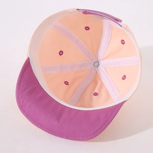 Detail view showing internal reinforced seams and purple eyelets of baby baseball cap