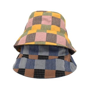 Summer plaid wide brim bucket hat for women with colorful checkered pattern on white background