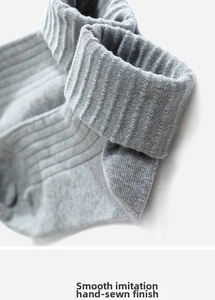 Detail of smooth imitation hand-sewn toe on light grey ribbed cotton sports socks