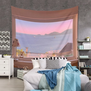 Detail of bohemian sunset sea view tapestry with sunset sky colors hanging on a bedroom wall