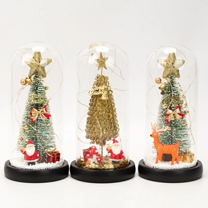 Three Christmas glass domes with LED trees, reindeer and Santa on black bases