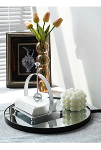 Detail of silver metal napkin holder with crystal weight and round support feet
