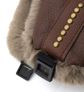 Detail of leather trapper hat featuring faux fur lining and vintage gold rivets