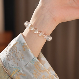 Detailed close-up of a white crystal beaded bracelet showing natural icy textures on wrist