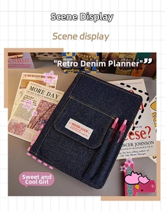 Detail of blue denim A5 notebook cover featuring GOOD LUCK patch and pen holders