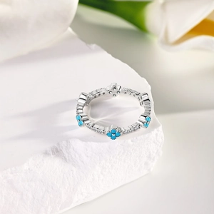 Macro shot of S925 silver ring with blue clover gemstones and white cubic zirconia details