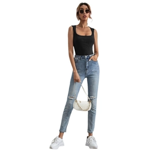 Women's black ribbed square neck tank top paired with light blue distressed jeans