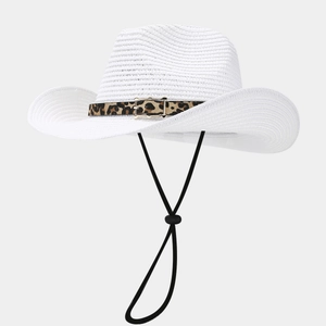 Detail of white straw cowboy hat featuring leopard print band and golden buckle