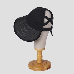 Detail of black sun hat with breathable cotton fabric and ponytail opening design