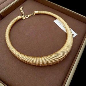 Detail of chunky gold spiral choker with lobster clasp and adjustable extension chain