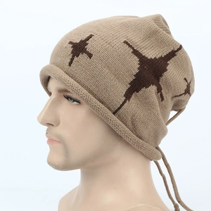 Detail of khaki beanie with star pattern and drawstring on thick knit fabric