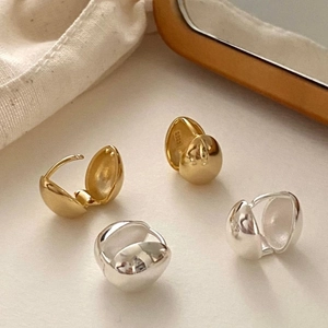 Minimalist S925 sterling silver sphere earrings in gold and silver on linen fabric