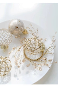 Macro detail of elegant gold and white Christmas ornaments with glitter and beadwork