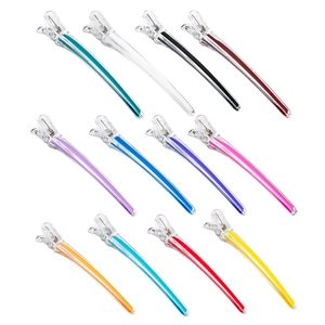 Set of 12 colorful transparent plastic hair styling clips with metal springs on white background