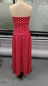 Detail view of the red and white polka dot long dress back with a refined waistline