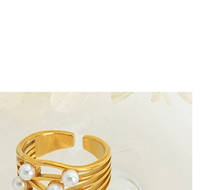 Detail of gold-plated multi-layer coiled ring featuring elegant white pearl accents