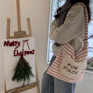 Detail of red and white striped faux fur tote bag with embroidered Fun Place pocket