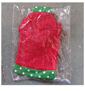 Detail of Christmas snowman wine bottle cover in festive red and green fabric packaging
