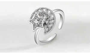 Detail view of silver spinner ring with rotating star and moon set with cubic zirconia