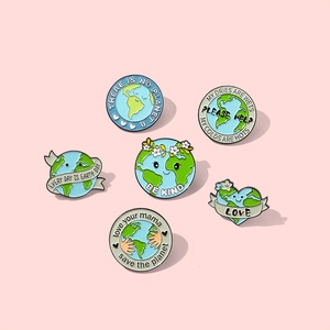Set of six Earth Day enamel pins with eco-friendly slogans on a soft pink background